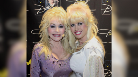 The image shows two women dressed up with vibrant makeup and sparkly dresses smiling for a picture.