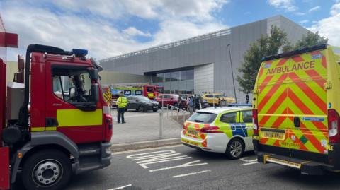 Police fire and ambulance service vehicles parked outside