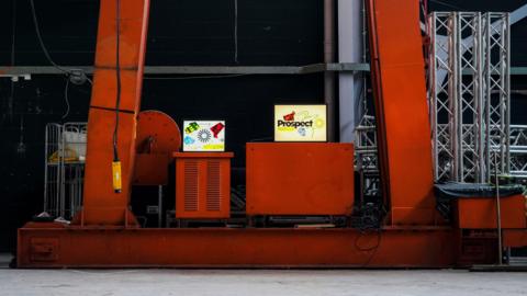 Red pillars and signage reading 'Prospect' in a warehouse