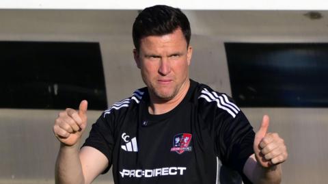 Exeter City manager Gary Caldwell holds two thumbs up
