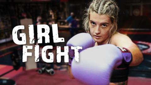 A girl in purple boxing gloves