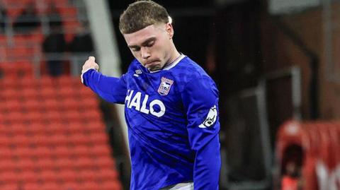 Leif Davis wearing a blue Ipswich Town shirt in action during a match