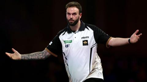 Ross Smith celebrates a darts victory by opening his arms