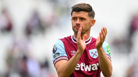Aaron Cresswell claps the crowd at the end of his final game for West Ham
