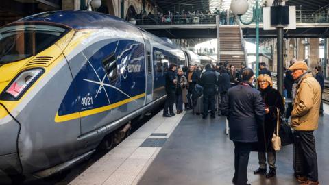Eurostar train on platform with passenger waiting