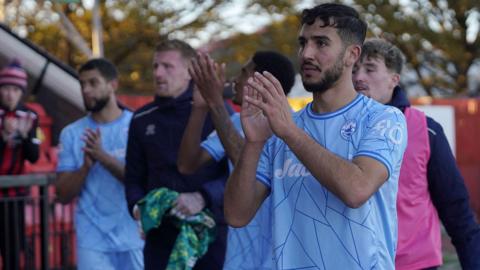 Truro City players applaud their fans