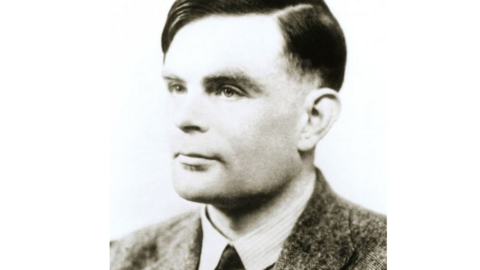 Black and white portrait photo of Alan Turing