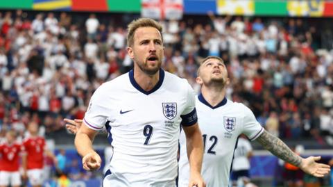 England's Harry Kane celebrates scoring their first goal with Kieran Trippier