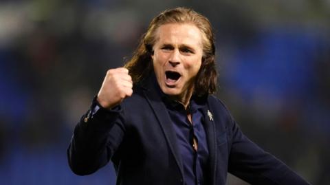 Close up of Gareth Ainsworth punching the air in celebration 