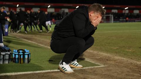 Karl Robinson looks dejected as Chesterfield score a late winner