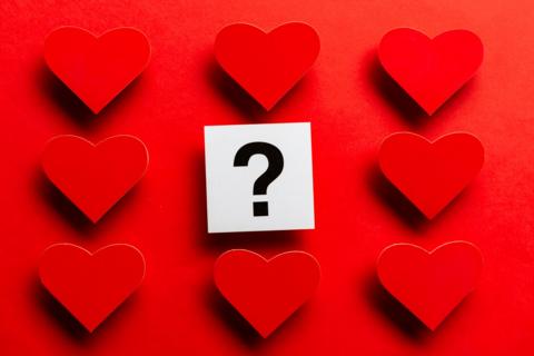 red hearts surrounding a question mark on a square