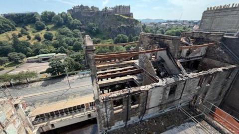 A general view of the wrecked builing on Princes Street showing exposed steelwork and brick.