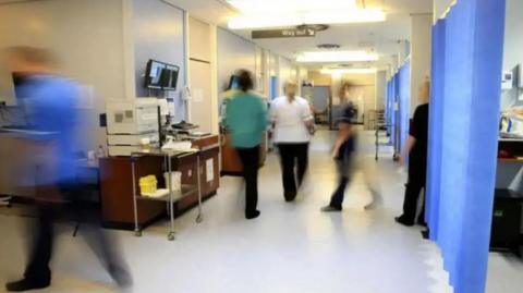 Medical staff in an NHS hospital ward.