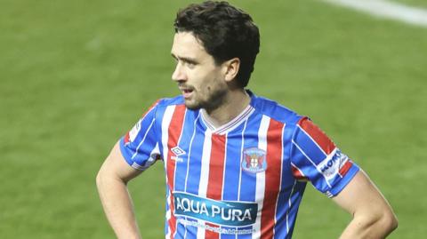 Alex Gilliead with his hands on his hips playing for Carlisle
