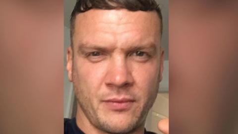 A selfie of Donovan Kitching - a man with dark hair and stubble.