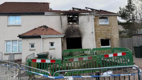 A general view of the fire-damaged house in the Hay Drive area of Niddrie.