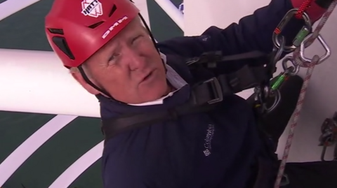 John Maguire wearing a red helmet about to descend down the Spinnaker Tower