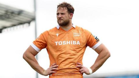 Sale Sharks' Jonny Hill stands with hands on hips looking on after the end of a match