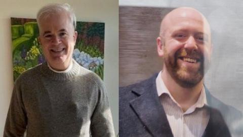 A side-by-side image of two separate portraits.
On the left, a person with short, light-colored hair stands indoors in front of a colorful painting of a garden scene. The person is wearing a grey knitted sweater and is positioned from the chest up against a light-colored wall.
On the right, another person is shown from the chest up indoors, standing against a wooden wall panel. The person is wearing a dark blazer over a light, collared shirt, with closely shaved hair and a full beard.