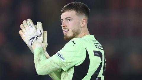 Leyton Orient goalkeeper Josh Keeley claps supporters 