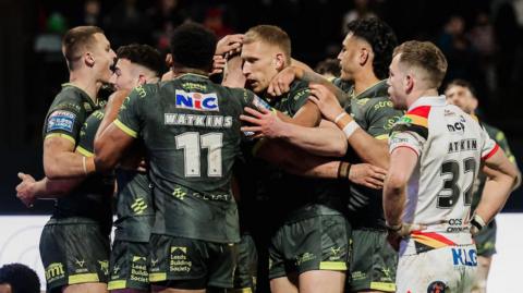James McDonnell of Leeds celebrates with team-mates after scoring a try