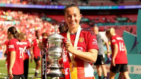 Maya Le Tissier holding the Women's FA Cup trophy