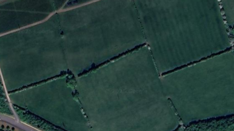 Birds eye image of the site which is currently green fields