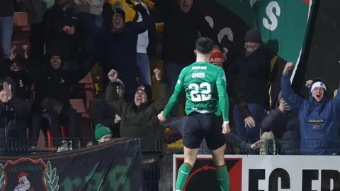 Danny Amos celebrates his goal