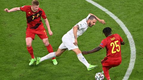 Kevin de Bruyne and Jeremy Doku in action for Belgium