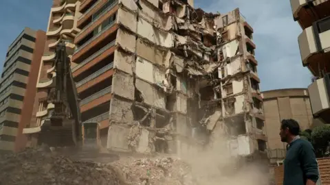 Man outside damaged building in Beirut