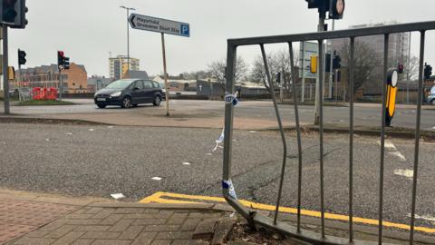 Horse Market at its junction with Lady's Lane. A metal barrier with remnants of police tape is shown as having been bent after being struck by a vehicle.