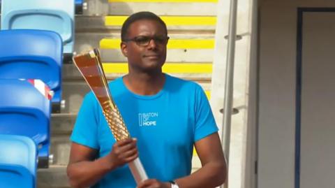 Baton bearer in Alexander Stadium, Birmingham