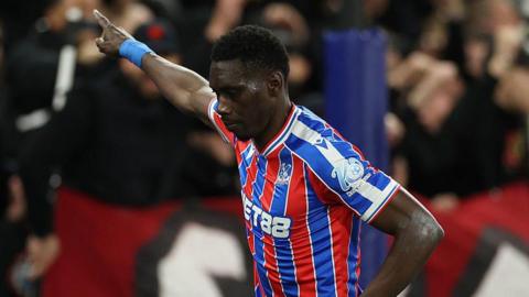 Ismaila Sarr points to the sky after scoring for Crystal Palace