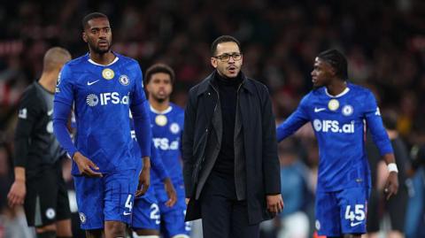 Tosin Adarabioyo, Andrey Santos, Liam Rosenior and Romeo Lavia walk off the pitch together after defeat at Arsenal