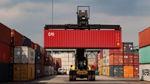 A reach stacker carries a container at the Packer Avenue Marine Terminal in Philadelphia, Pennsylvania, US, on Wednesday, April 10, 2024. 