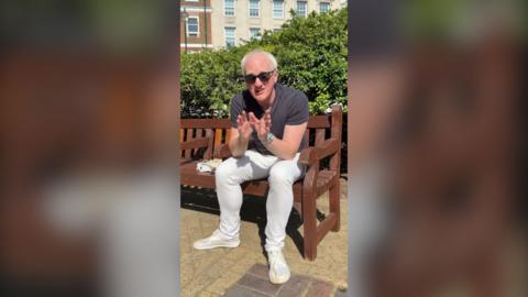 James Gallagher in a park wearing sunglasses