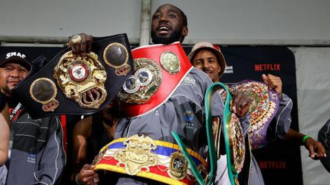 Terence Crawford poses with his new super-middleweight titles