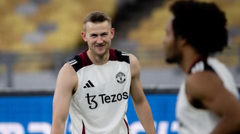 Manchester United defender Matthijs de Ligt smiles at Dutch team-mate Joshua Zirkzee during the post-season trip to Asia