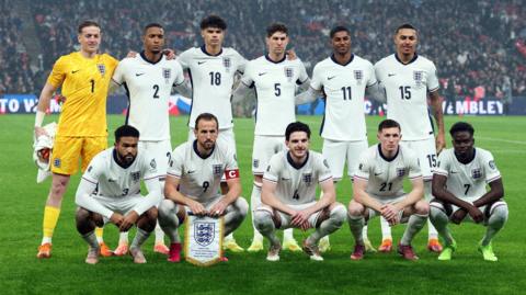 England players pose for a team group photo before the match.