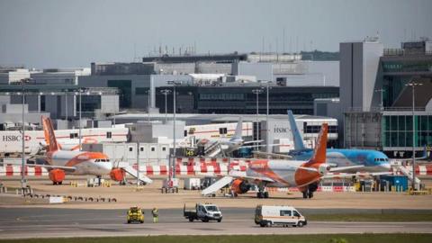 A shot of planes parked outside a terminal at Gatwick Airport