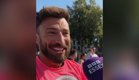 Jake Quickenden wearing pink T-shirt and being interviewed by 鶹Լ Essex