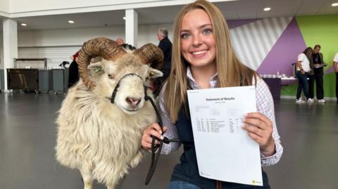 Milly Johnson, 16, and her sheep Kevin receiving her GCSE results at Tarleton Academ