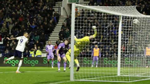 Daniel Jebbison watches as his header goes past Sheffield United goalkeeper and towards the net