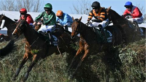 Jockey Patrick Mullins (2R) jumps The Chair on Nick Rockett on the first circuit on the way to winning the Grand National Handicap Chase on the final day of the Grand National Festival horse race meeting at Aintree Racecourse in Liverpool,