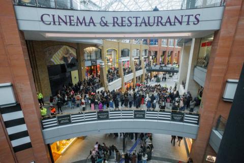 A crowd queues