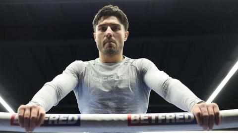Josh Kelly leans over the ropes