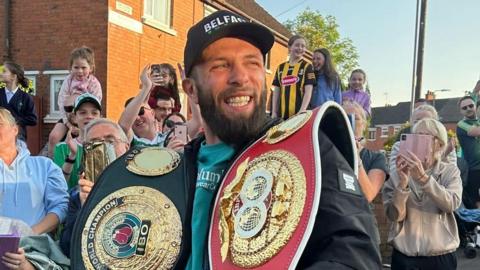 Boxing world champion Anthony Cacace received a hero's welcome on his return to west Belfast on Monday