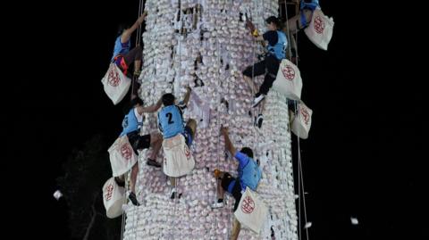 Participants compete to climb a 14-metre bun tower during the bun-snatching competition.