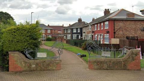 A row of houses with a path in front