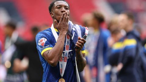 Josh Neufville celebrates winning promotion with AFC Wimbledon